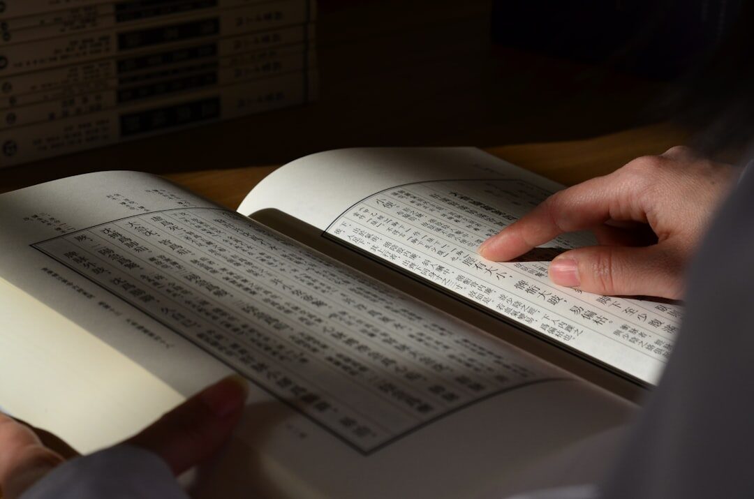 person studying japanese coding book