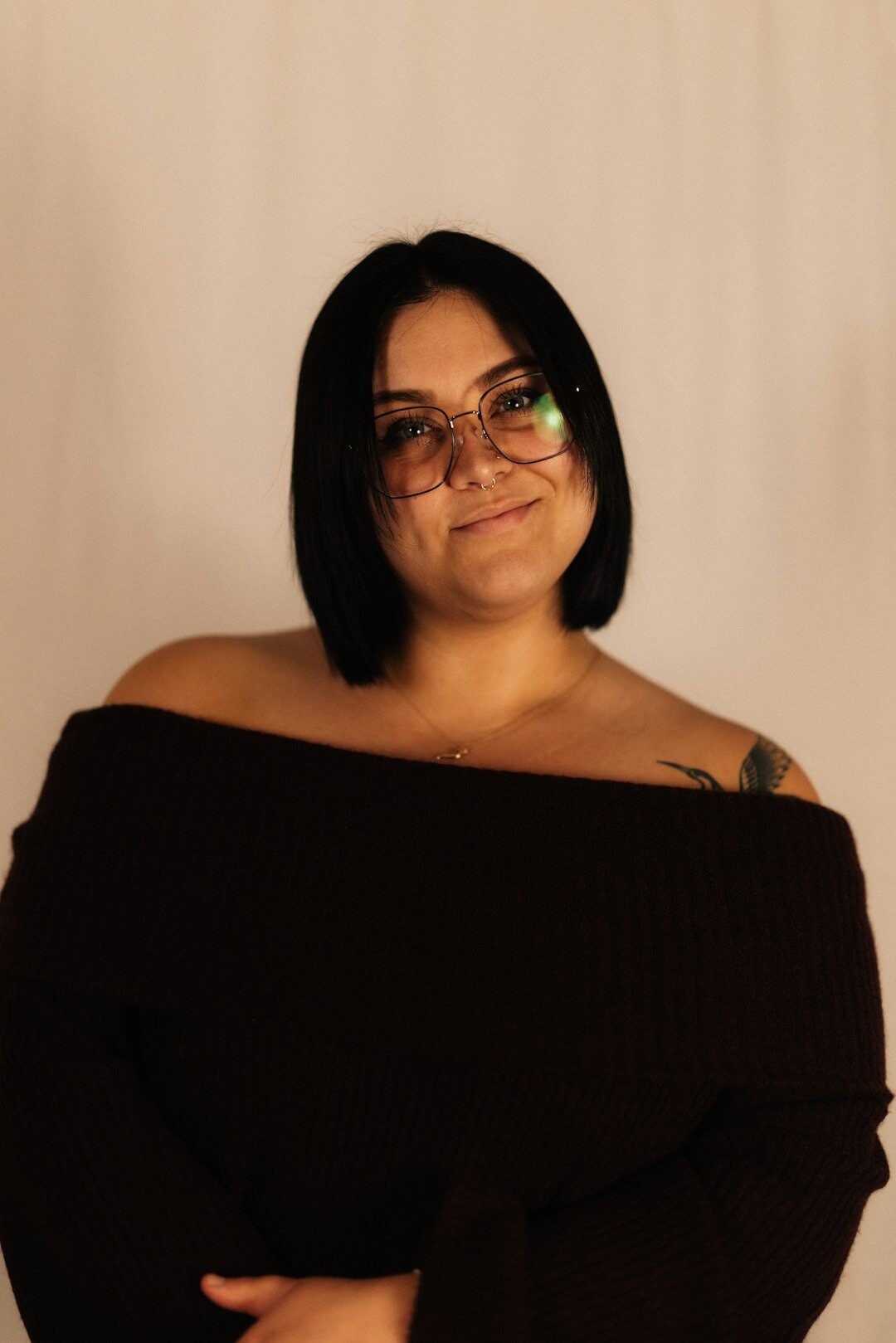 Studio portrait of a woman with glasses smiling
