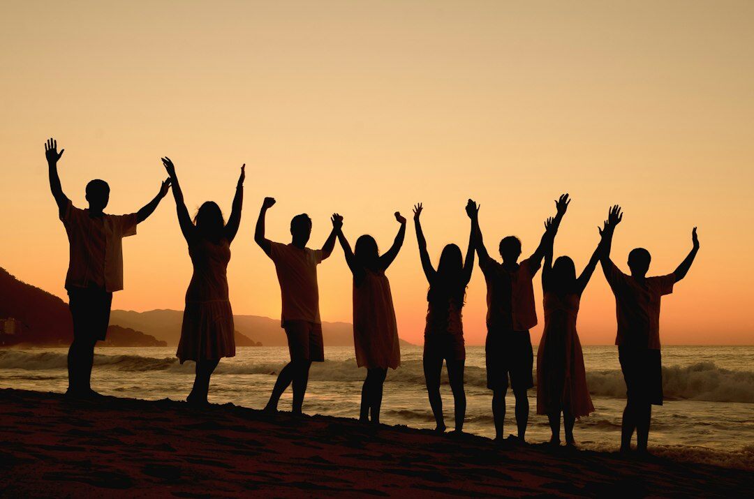 Diverse team celebrating with a high five in an office