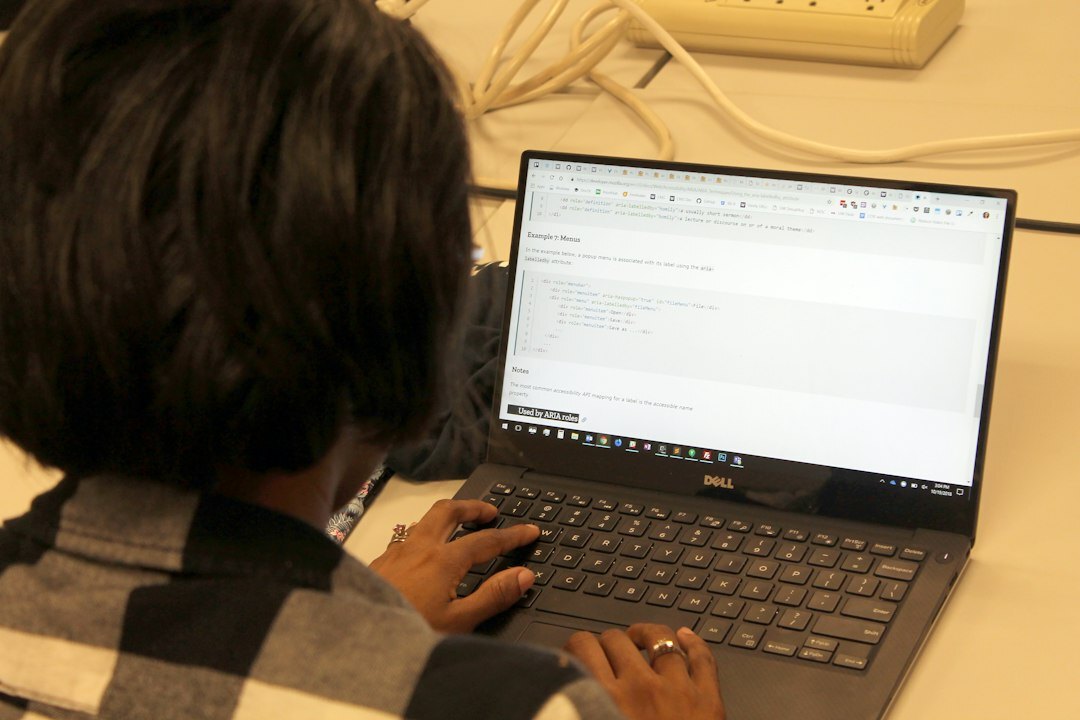 japanese student coding on laptop